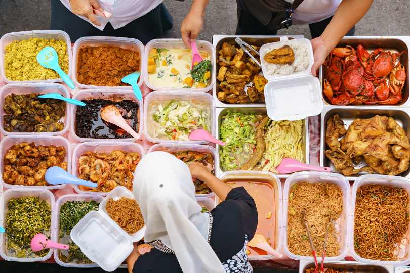 Muslim woman serving halal street food