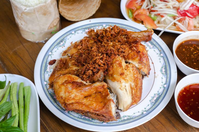 Plate of fried chicken covered with crispy shallots