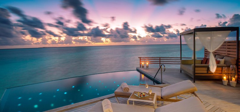 Water pool villa at sunset in Baros Maldives