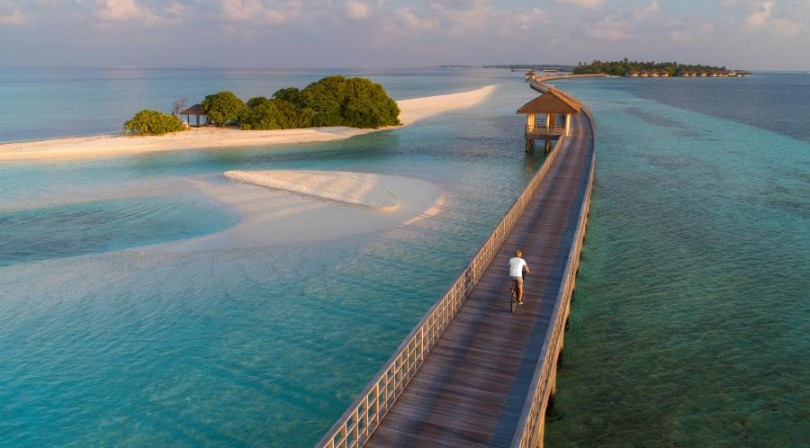 Cycling along bridge in the Reisdence Dhigurah Maldives