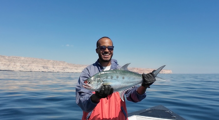 Walid Haji holding a fish in Oman