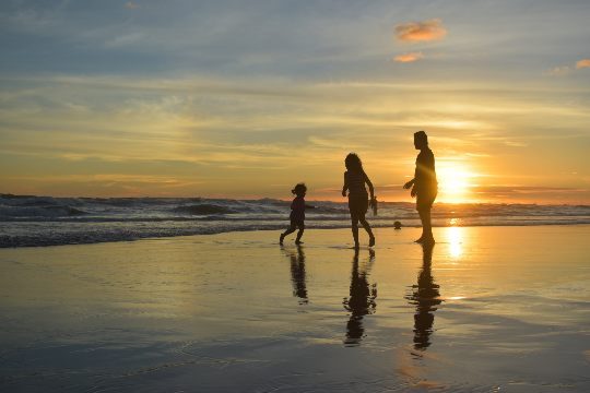 Family playing on a beach holiday